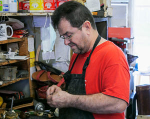 Cobbler working in his shop